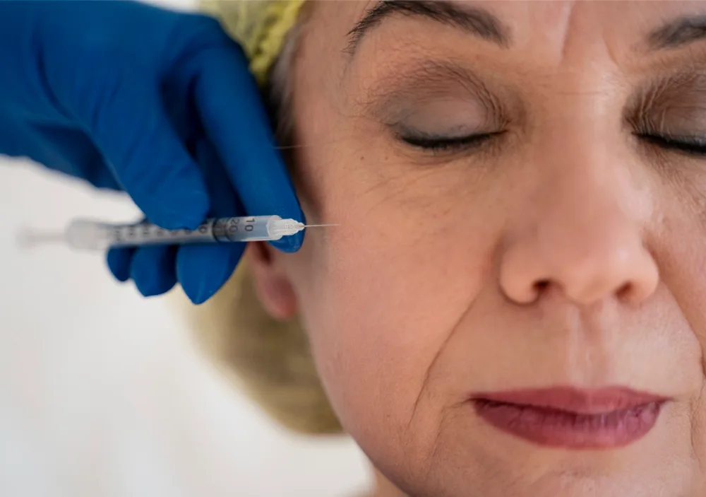 Woman getting injection for anti aging treatment